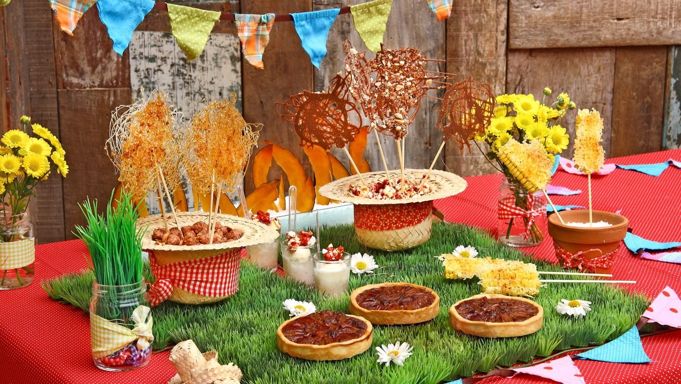 Festive carnival themed food counter with colourful bunting, treats and decorated snack stands